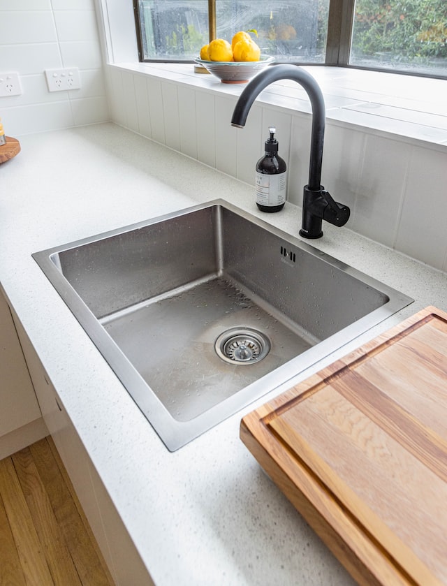 Stainless steel kitchen sink with garbage disposal.